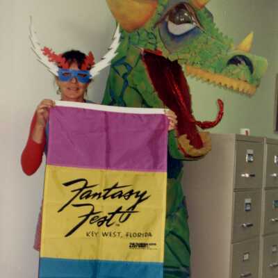 Unknown woman holding a FF flag standing near a dragon.