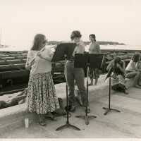 A group of unknown people playing flutes