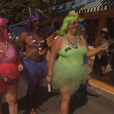 Three unknown people dressed up.