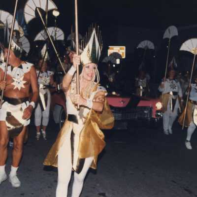 Unknown people walking on the street in the parade.