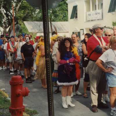 A group of unknown people waiting in a line.