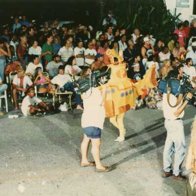 Unknown people holding cameras waiting on the float to come down Duval street.