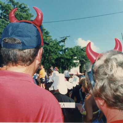 Unknown couple wearing devil horns.