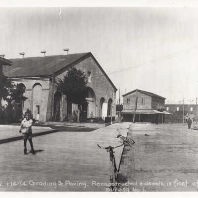 Child and bicycles in front of Building No. 1, Key West