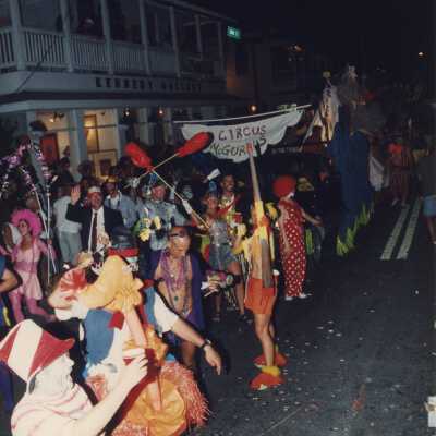 Unknown people dressed up walking on the street for the parade.