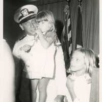 An unknown man in uniform with 2 kids