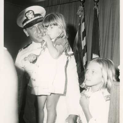 An unknown man in uniform with 2 kids