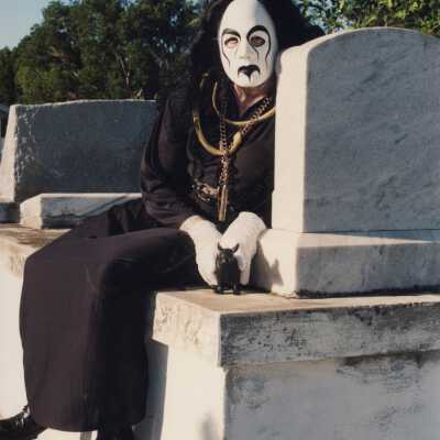 Unknown person dressed up at the cemetery.