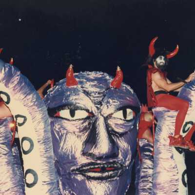 Unknown people dressed up sitting on a float.