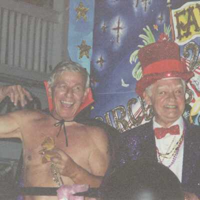 Two unknown men dressed up on a float.