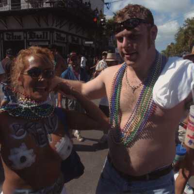 Two unknown people , one has her breast painted.