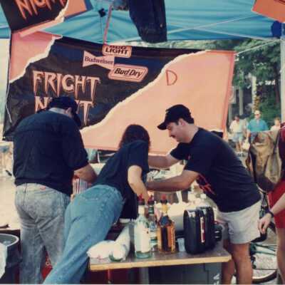 Unknown people working at the street fair booth.