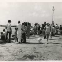 A group of unknown people on a pier