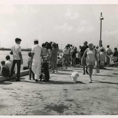 A group of unknown people on a pier