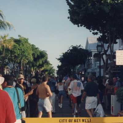 A group of people walking down Duval Street.