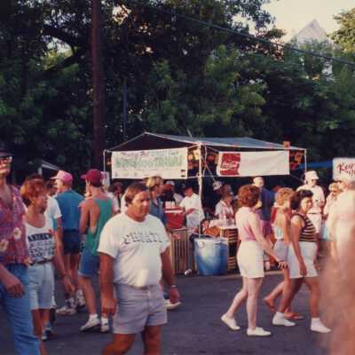 Unknown people walking on the street at the fair.
