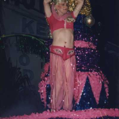 An unknown woman dressed up on a float in the parade.