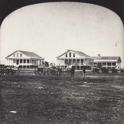 Men and cannons in front of the Army Barracks
