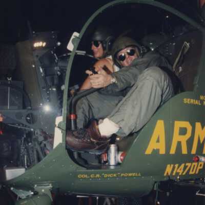 Unknown people on a float that is an Army helicopter.