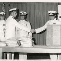 4 Unknown men in uniform standing near a podium