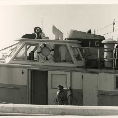 Unknown man cleaning a boat