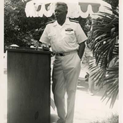 U.S. Military man leaning against a podium