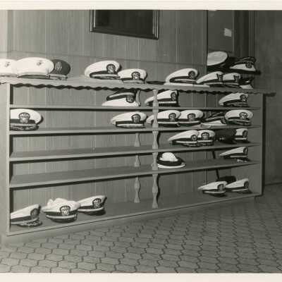 A shelf with military hats
