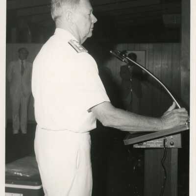 An unknown man in uniform standing at a podium