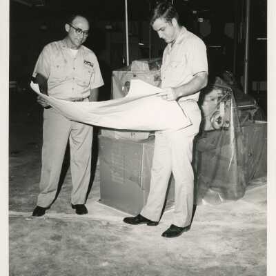 U.S. Navy men looking at plans