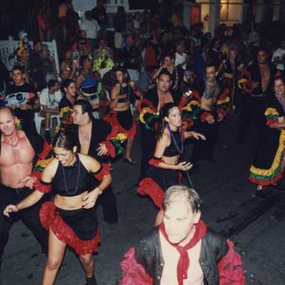 Unknown people dancing in the street in the parade.