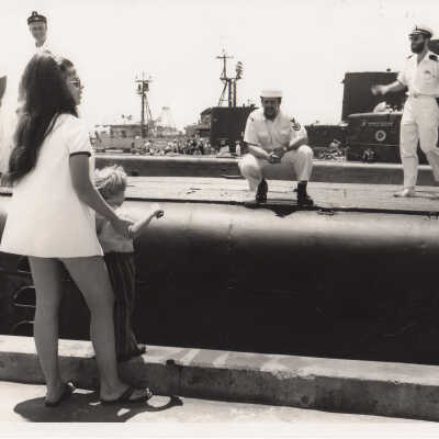 People on a pier near submarines