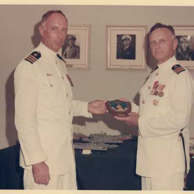 U.S. Navy men with a plaque