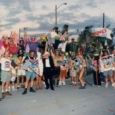 Capt. Tony with a group of unknown people standing next to a few floats.