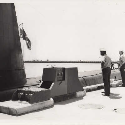 Sailors on a pier near a submarine