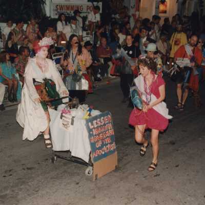 Unknown people dressed up walking in the street for the parade.