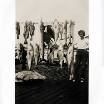 Lady Angler Poses Proudly beside a Great Day's Catch