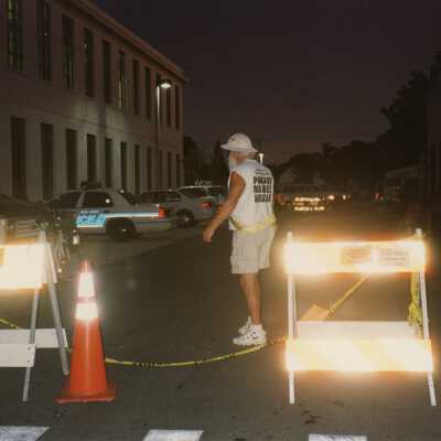 Unknown man standing on a blocked off street.