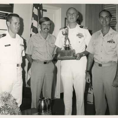 Men in uniform receiving an award