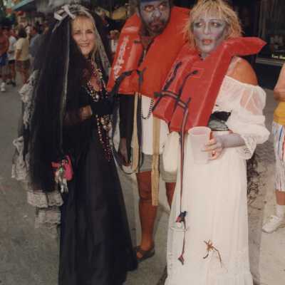 Three unknown people dressed up.
