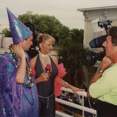 Unknown people dressed up talking with a man that is video tapping them.