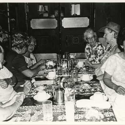 A group of unknown woman sitting at a table