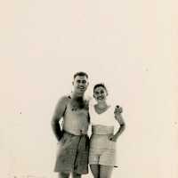 An unknown couple standing at the beach