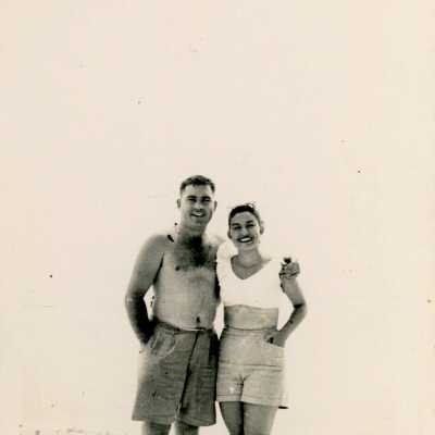 An unknown couple standing at the beach