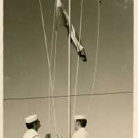 2 Men in uniform with a flag