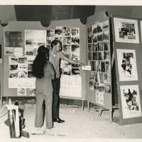 2 Unknown people looking at photographs