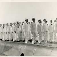 A group of men in uniform standing on a ship