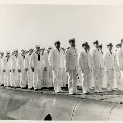 A group of men in uniform standing on a ship
