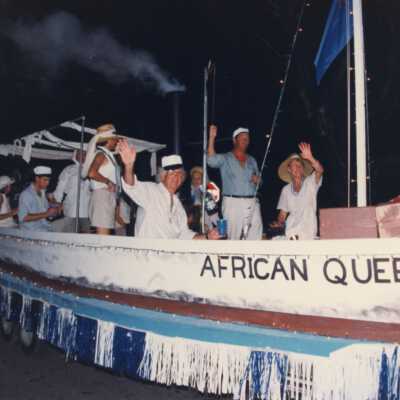 Unknown people dressed up on a float that reads African Queen.