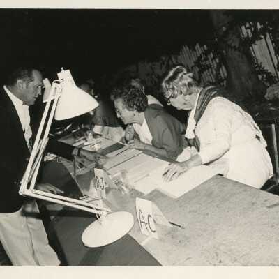 Unknown people looking at paperwork on a table