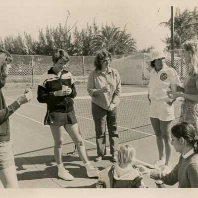 A group of people at the tennis courts